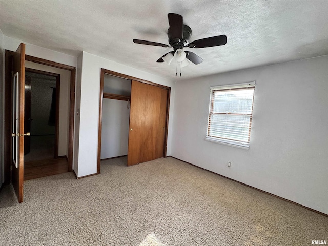 1275 Sunview Dr, Canton, IL 61520 - unfurnished bedroom featuring a closet, light carpet, a textured ceiling, and a ceiling fan
