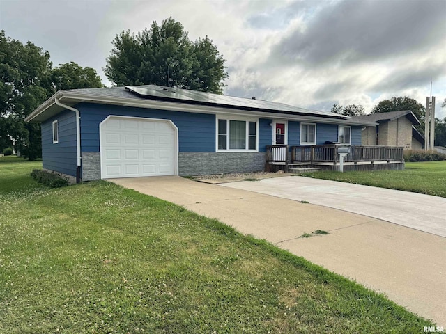 1275 Sunview Dr, Canton, IL 61520 - ranch-style house with roof mounted solar panels, a garage, a front lawn, and stone siding
