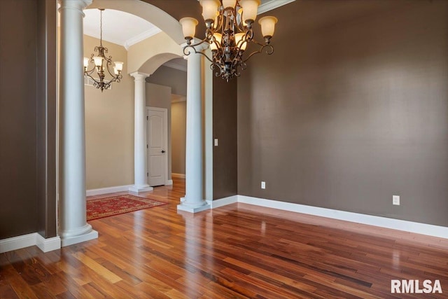 4408 Foxhall Ln, Springfield, IL 62711 - unfurnished dining area with crown molding, a chandelier, wood finished floors, and arched walkways