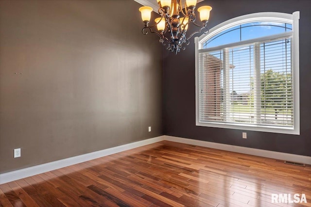 4408 Foxhall Ln, Springfield, IL 62711 - unfurnished room with a chandelier and wood finished floors