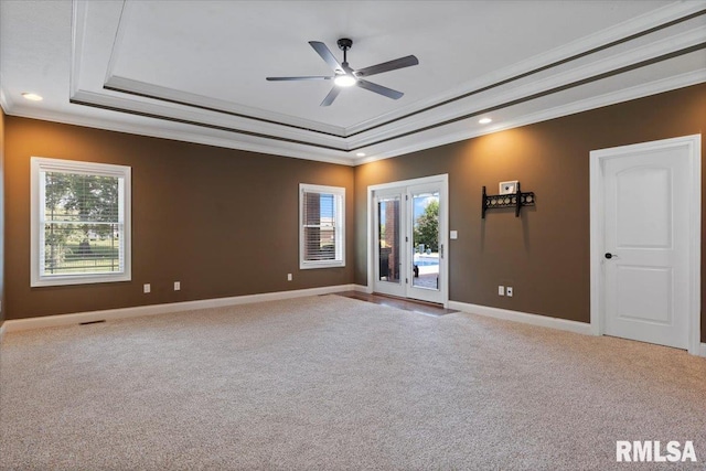 4408 Foxhall Ln, Springfield, IL 62711 - empty room featuring a raised ceiling, plenty of natural light, ceiling fan, crown molding, and carpet flooring