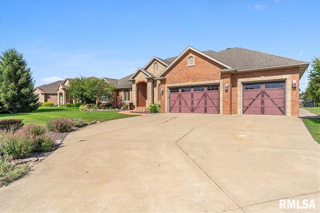 4408 Foxhall Ln, Springfield, IL 62711 - craftsman-style house featuring brick siding, a front lawn, an attached garage, and driveway