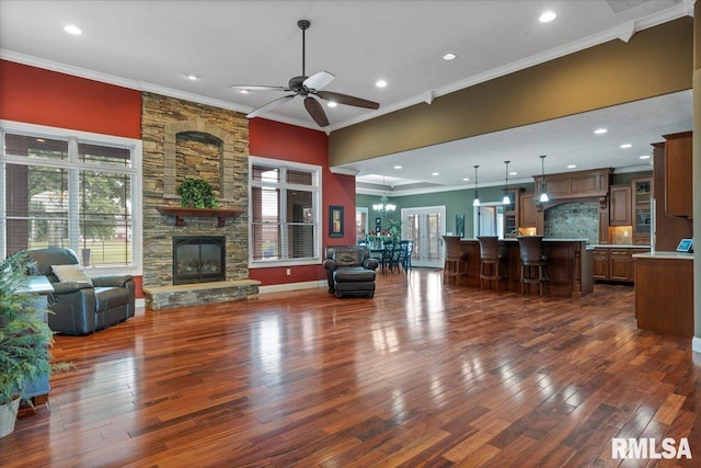 4408 Foxhall Ln, Springfield, IL 62711 - living area with ornamental molding, dark wood finished floors, a ceiling fan, a stone fireplace, and recessed lighting