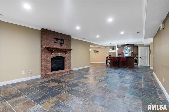 4408 Foxhall Ln, Springfield, IL 62711 - living room with stone tile flooring, recessed lighting, crown molding, and a fireplace