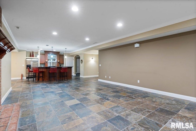 4408 Foxhall Ln, Springfield, IL 62711 - living room featuring stone tile floors, arched walkways, recessed lighting, and crown molding