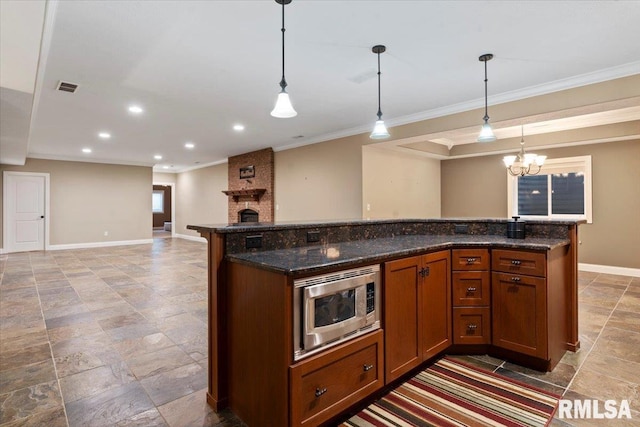 4408 Foxhall Ln, Springfield, IL 62711 - kitchen featuring stainless steel microwave, crown molding, stone tile floors, a chandelier, and hanging light fixtures