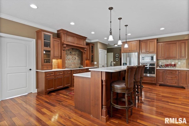 4408 Foxhall Ln, Springfield, IL 62711 - kitchen featuring stainless steel appliances, brown cabinets, decorative backsplash, light countertops, and recessed lighting