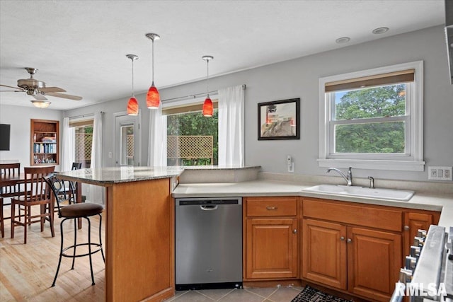 14 Beachview Ln, Springfield, IL 62712 - kitchen with stainless steel dishwasher, plenty of natural light, a peninsula, and brown cabinetry