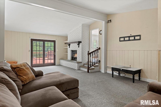 14 Beachview Ln, Springfield, IL 62712 - living area with carpet flooring, a brick fireplace, stairs, lofted ceiling, and wooden walls