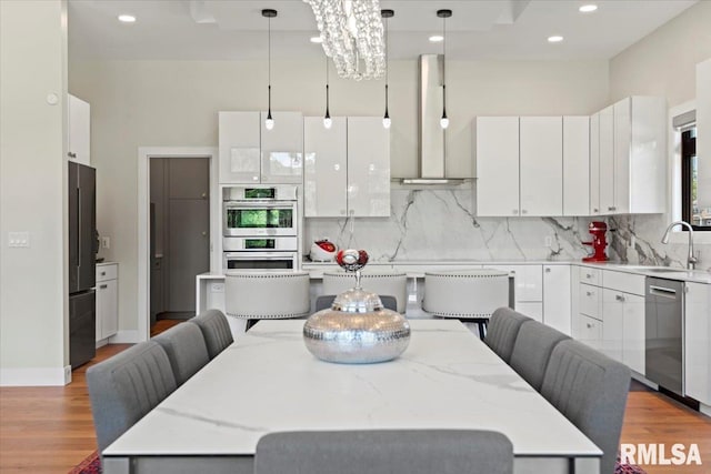 2004 Grants Pond, Chatham, IL 62629 - kitchen featuring stainless steel appliances, tasteful backsplash, light wood-type flooring, a kitchen breakfast bar, and recessed lighting