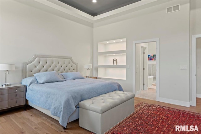 2004 Grants Pond, Chatham, IL 62629 - bedroom featuring light wood-type flooring, recessed lighting, connected bathroom, and a towering ceiling