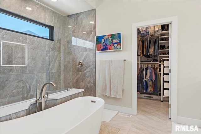 2004 Grants Pond, Chatham, IL 62629 - full bathroom featuring a freestanding tub, a spacious closet, marble look tiles, and a walk in shower