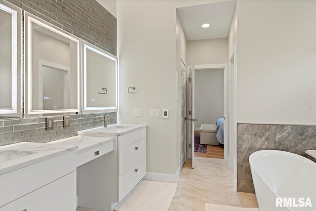 2004 Grants Pond, Chatham, IL 62629 - full bathroom featuring double vanity, a freestanding tub, and connected bathroom