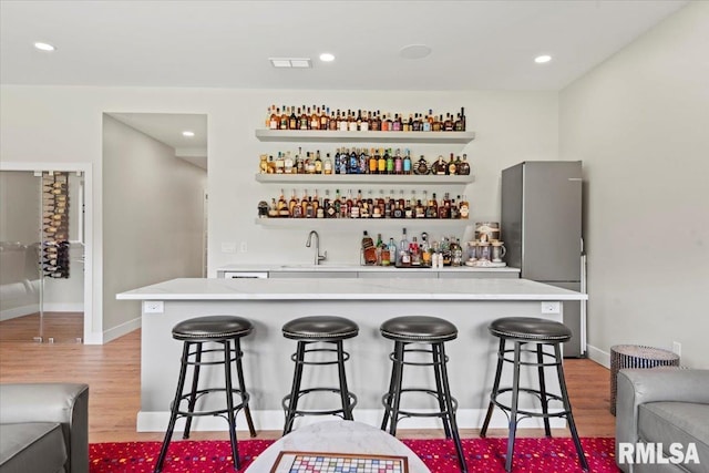 2004 Grants Pond, Chatham, IL 62629 - indoor wet bar with light wood-style flooring, freestanding refrigerator, and recessed lighting