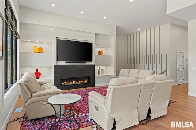 2004 Grants Pond, Chatham, IL 62629 - living area with wood finished floors, a glass covered fireplace, recessed lighting, and built in features