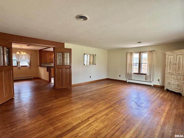 161 Hawkinson Ave, Galesburg, IL 61401 - unfurnished room with a baseboard radiator, wood finished floors, and a chandelier