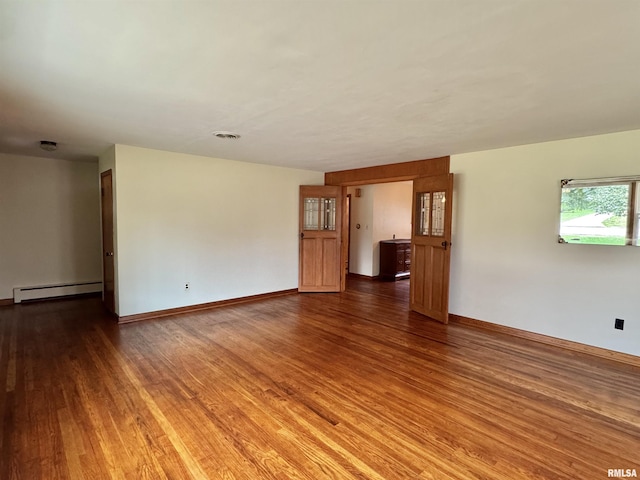 161 Hawkinson Ave, Galesburg, IL 61401 - unfurnished room featuring baseboard heating and wood finished floors