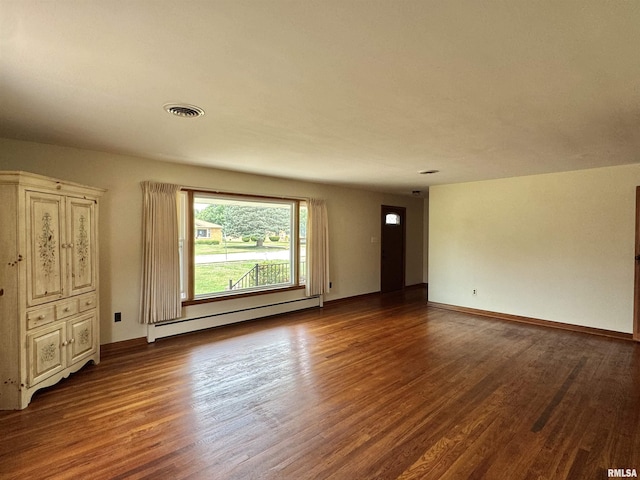 161 Hawkinson Ave, Galesburg, IL 61401 - spare room featuring a baseboard radiator and dark wood-style floors