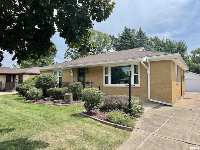 161 Hawkinson Ave, Galesburg, IL 61401 - ranch-style house with brick siding, a front yard, a porch, and a detached garage