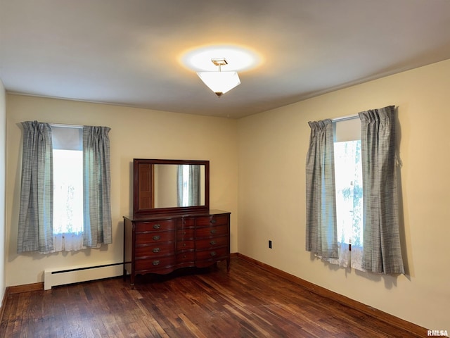 161 Hawkinson Ave, Galesburg, IL 61401 - unfurnished bedroom featuring a baseboard radiator and wood finished floors