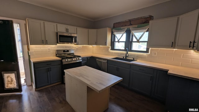 927 Sycamore St, Quincy, IL 62301 - kitchen featuring stainless steel appliances, ornamental molding, dark wood-style floors, tasteful backsplash, and white cabinets