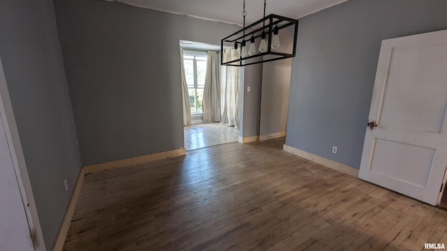 927 Sycamore St, Quincy, IL 62301 - unfurnished dining area with hardwood / wood-style floors, a chandelier, and ornamental molding