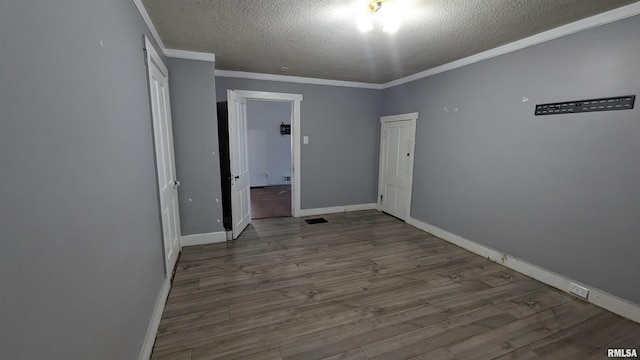 927 Sycamore St, Quincy, IL 62301 - unfurnished bedroom with a textured ceiling, crown molding, and wood finished floors