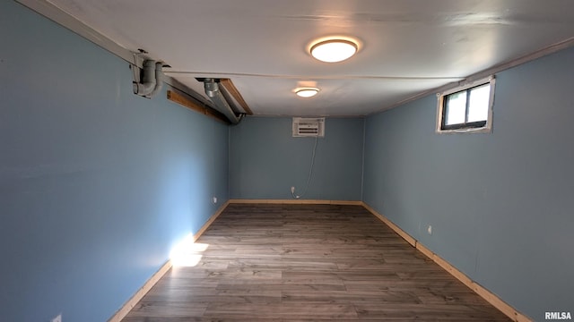 927 Sycamore St, Quincy, IL 62301 - below grade area featuring wood finished floors and a wall unit AC