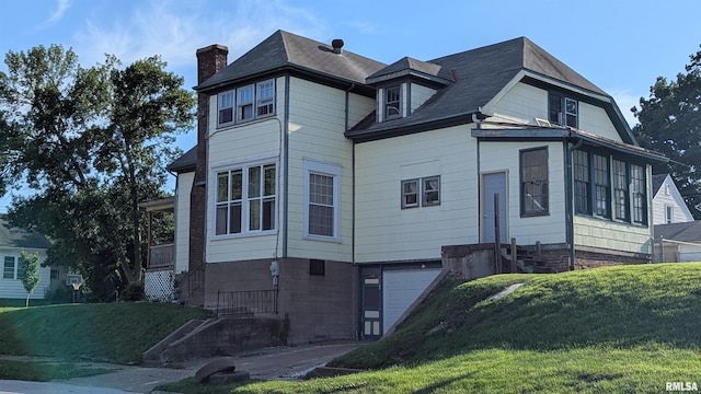 927 Sycamore St, Quincy, IL 62301 - view of property exterior with a garage, a chimney, and a lawn