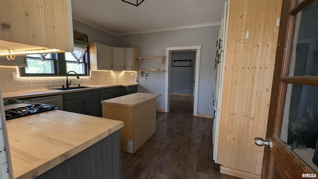 927 Sycamore St, Quincy, IL 62301 - kitchen with cooktop, backsplash, crown molding, dark wood-style flooring, and a kitchen island