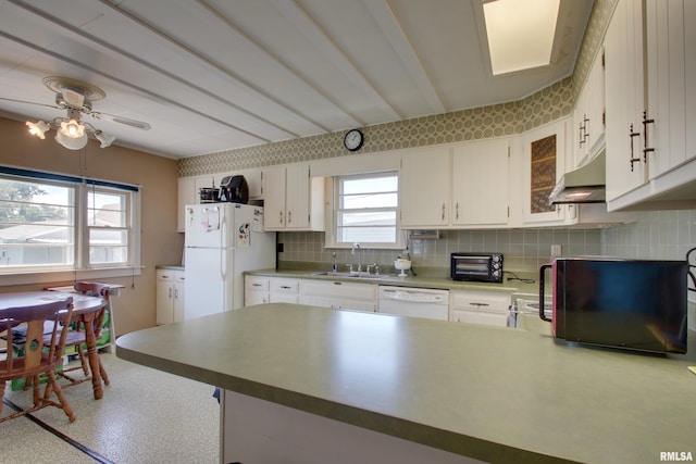 2716 Elm St, Quincy, IL 62301 - kitchen with white appliances, under cabinet range hood, ceiling fan, tasteful backsplash, and a peninsula