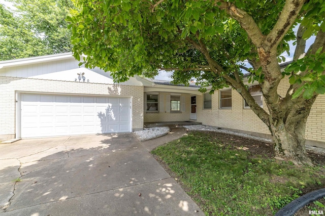 2700 Northridge Dr, Quincy, IL 62301 - single story home with brick siding, concrete driveway, and an attached garage
