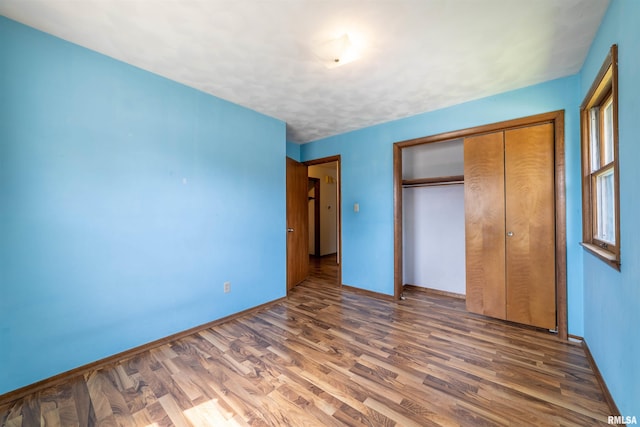 2700 Northridge Dr, Quincy, IL 62301 - unfurnished bedroom featuring wood finished floors and a closet