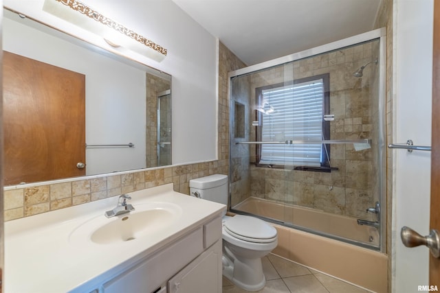2700 Northridge Dr, Quincy, IL 62301 - bathroom featuring vanity, shower / bath combination with glass door, tile patterned flooring, and tile walls