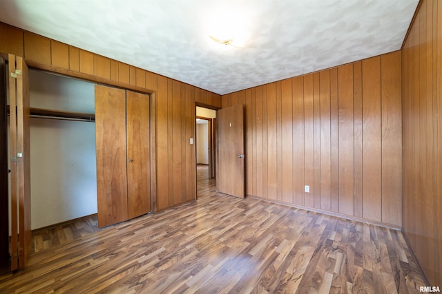 2700 Northridge Dr, Quincy, IL 62301 - unfurnished bedroom with a closet, wood finished floors, and wooden walls