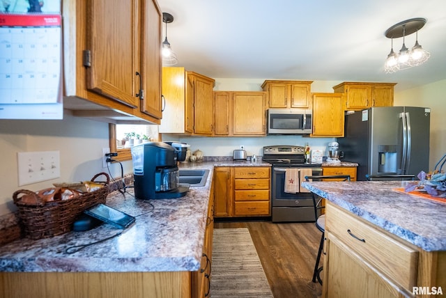 23490 E Maple Rd, Bluford, IL 62814 - kitchen featuring stainless steel appliances, dark wood-style flooring, decorative light fixtures, brown cabinetry, and light countertops