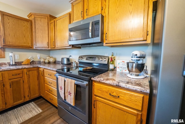 23490 E Maple Rd, Bluford, IL 62814 - kitchen with stainless steel appliances, dark wood-style floors, and brown cabinets