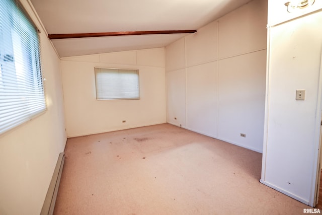 29498 420th St, Griggsville, IL 62340 - empty room featuring vaulted ceiling, light colored carpet, and a baseboard heating unit