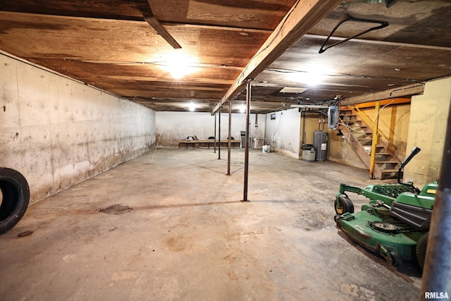 29498 420th St, Griggsville, IL 62340 - unfinished basement featuring electric water heater, stairway, and electric panel