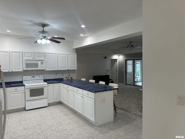 4004 Abbey Ridge St, Quincy, IL 62305 - kitchen with a ceiling fan, a peninsula, white appliances, a breakfast bar area, and recessed lighting