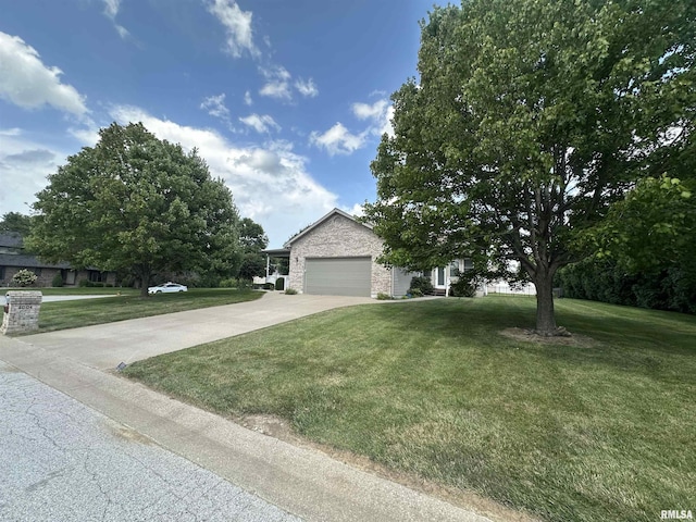 4004 Abbey Ridge St, Quincy, IL 62305 - view of front of house with an attached garage, a front lawn, driveway, and brick siding
