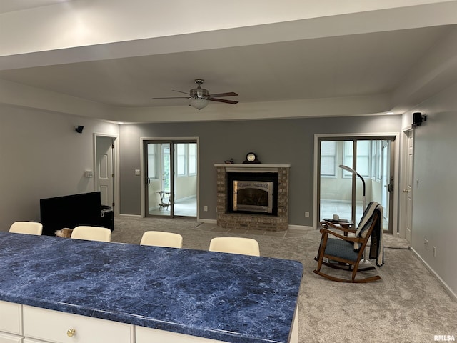 4004 Abbey Ridge St, Quincy, IL 62305 - carpeted living area featuring ceiling fan and a brick fireplace