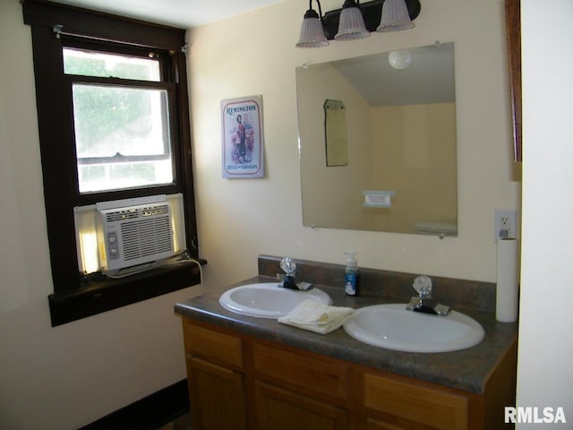 bathroom with double sink vanity and plenty of natural light