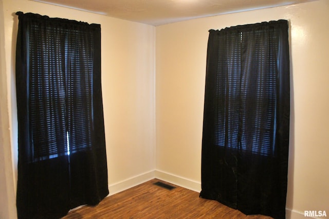 unfurnished room with dark hardwood / wood-style floors