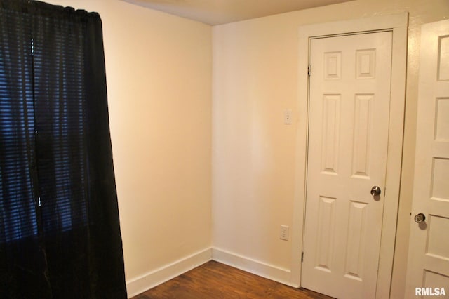 empty room featuring dark wood-type flooring