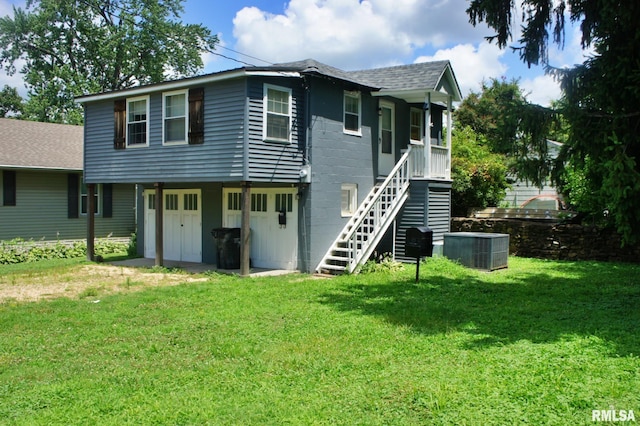 rear view of property featuring central AC unit and a yard