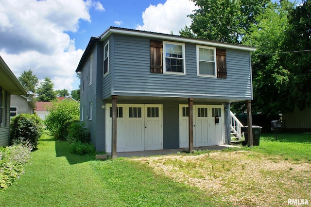 view of front property with a front yard, a porch, and a garage