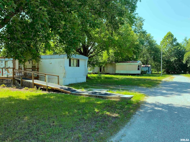 view of yard featuring a wooden deck and an outdoor structure