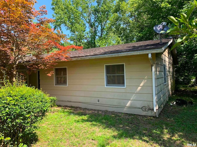 view of property exterior with a lawn