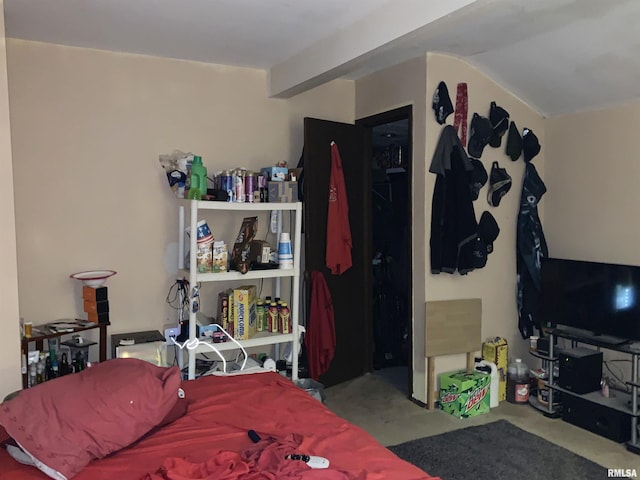 carpeted bedroom with beam ceiling